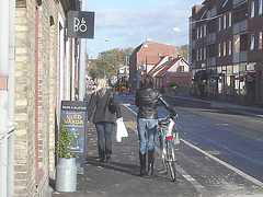 Cycliste en bottes à talons hauts / Walking Swedish biker in jeans & high-heeled boots at her cell phone - Ängelholm  / Suède - Sweden.  23-10-2008