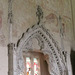 belchamp walter church, essex, john boutetort, c14 tomb canopy with square cut hole to cusps in line with tudor window. contemporary paintings cover the walls.c.1325