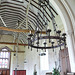 belchamp walter church essex,c14 nave interior with chimney from tortoise stove going up into roof and good victorian corona.