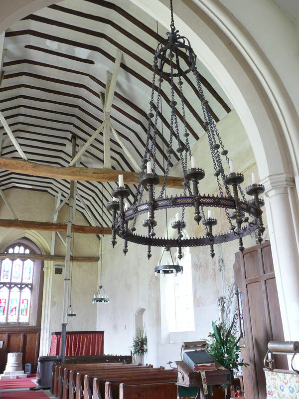 belchamp walter church essex,c14 nave interior with chimney from tortoise stove going up into roof and good victorian corona.