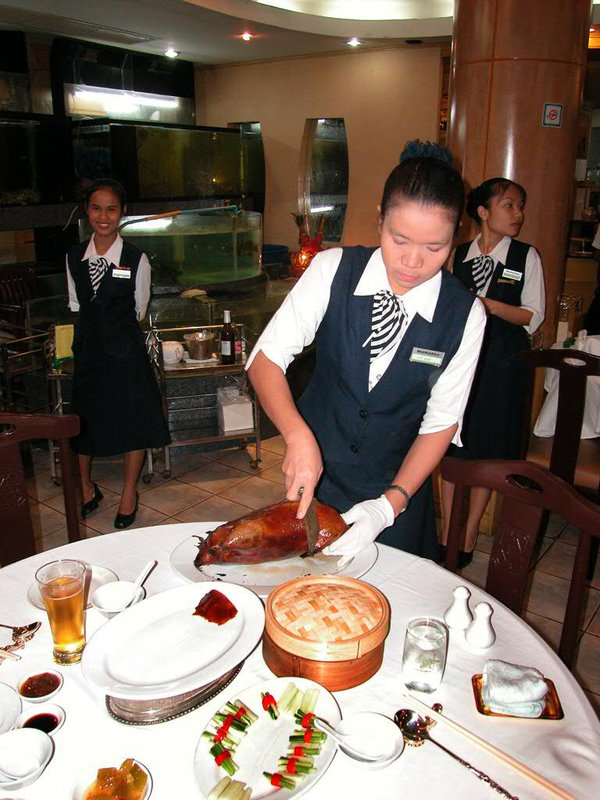 Serving Peking Duck in a Chinese Restaurant
