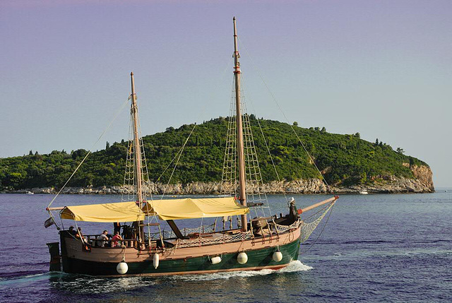 Tourist touring boat passes Otok Lokrum island