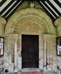 quenington church, glos.the mid c12 north doorway has big flowers down the sides, and a harrowing of hell tympanum.