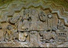 quenington church, glos.mid c12 south doorway tympanum with the coronation of virgin, four symbols of the evangelists, a halo'd face (sun?), and a seraph, with heaven's architecture on the right