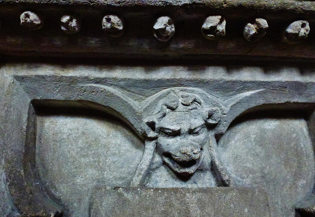 cogges church, oxon.ball flower above lion heads holding shields on side of early c14 chest tomb in north chapel