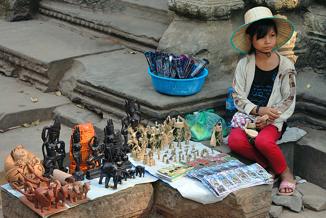 Young souvenir vendor inside Ta Prohm