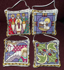 four ornaments depicting carols