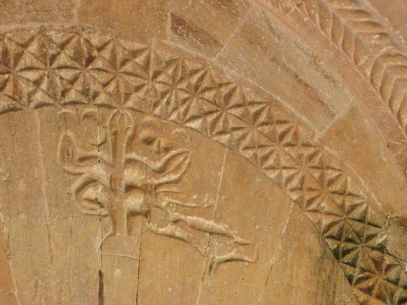 swell glos. c.1130 tympanum,a bird pecks at fruit on a tree of life