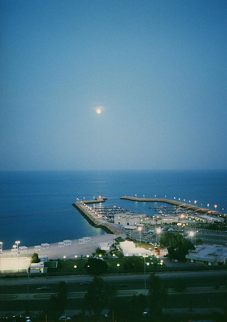 The moon rises over the Persian Gulf