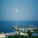 The moon rises over the Persian Gulf