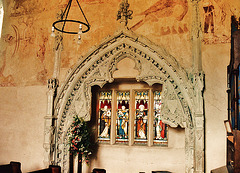 belchamp walter church, essex, john boutetort, c14 tomb canopy with square cut hole to cusps in line with tudor window. contemporary paintings cover the walls.c.1325