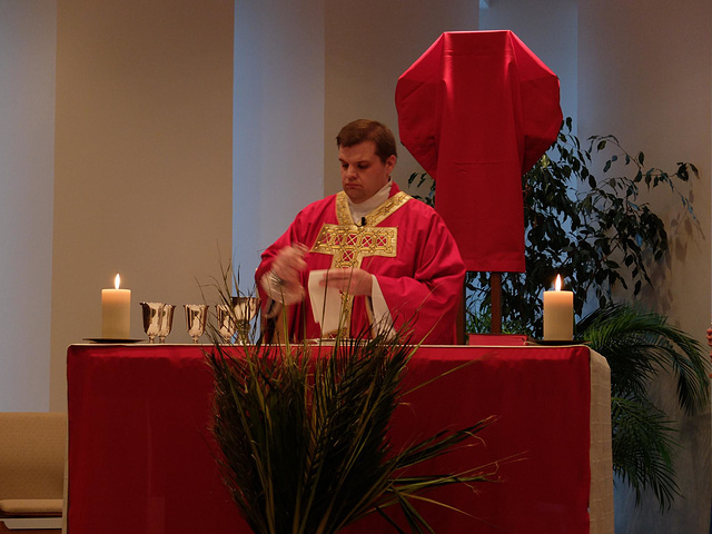 Father Mark prepares for Communion