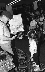 Showing some of his work to a child