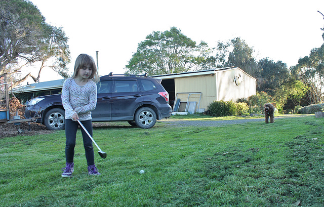 Eliza and Coco play golf