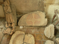 holy trinity, bottisham,part of the lapidary museum on the floor of the north aisle, mostly c13 or c14 tombs, with a c12 font. the large relief cross looks like an early c12 tympanum