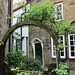 Wesley Cottage, through an arch.