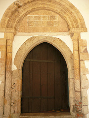 st.martin's church, eynsford,early c12 doorway, repositioned in the c13. at some point there seems to have been a rectangular panel within the tympanum, but it is unreadable now. the inner doorway and door seem c13