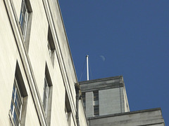 Blue sky, flagpole and moon