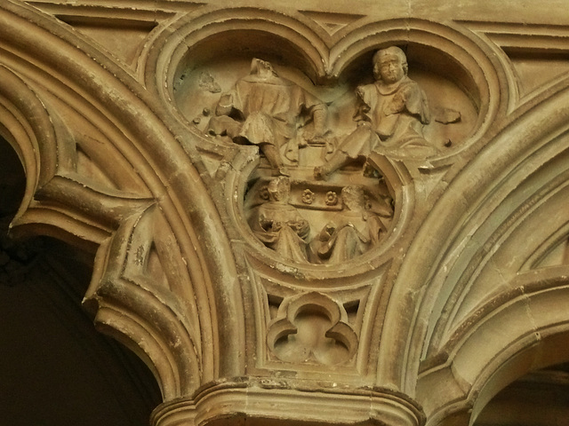 canterbury cathedral, c14detail of monks at lecterns and disputing fill the spandrels of the canopy on the tomb built for archbishop meopham , who died in 1333 makes a screen across the entrance to th