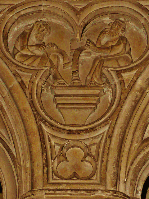 canterbury cathedral,c14 detail of monks at lecterns and disputing fill the spandrels of the canopy on the tomb built for archbishop meopham , who died in 1333 makes a screen across the entrance to th