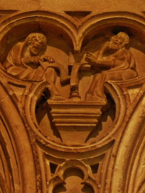 canterbury cathedral,c14,detail of monks at lecterns and disputing fill the spandrels of the canopy on the tomb built for archbishop meopham , who died in 1333 makes a screen across the entrance to th
