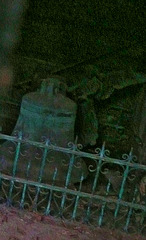 brompton cemetery, earls court,  london,this unusual sight of an angel and bell can be seen in one of the catacombs, difficult to photo through the thin slits in the great doors