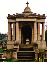 brompton cemetery, earls court,  london,designed in 1838 by benjamin baud, the arcades flanking the central path lead to a circus of similar arcades, with a circular chapel as the point de vue. there are catacombs below some of the arcades.