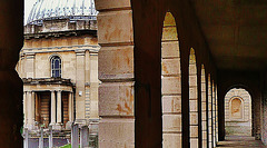 brompton cemetery, earls court,  london,designed in 1838 by benjamin baud, the arcades flanking the central path lead to a circus of similar arcades, with a circular chapel as the point de vue. there are catacombs below some of the arcades.