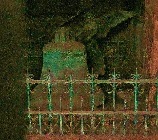 brompton cemetery, earls court,  london,this unusual sight of an angel and bell can be seen in one of the catacombs, difficult to photo through the thin slits in the great doors