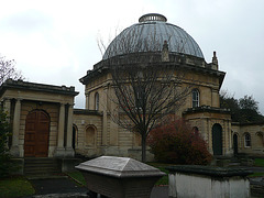 brompton cemetery, earls court,  london,designed in 1838 by benjamin baud, the arcades flanking the central path lead to a circus of similar arcades, with a circular chapel as the point de vue. there are catacombs below some of the arcades.