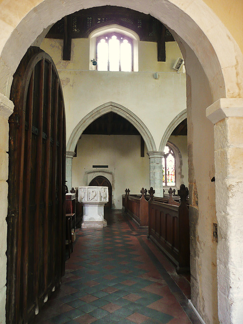 high easter church, essex,south door to church through c16 porch, c11 norman doorway into big norman church with c14 north aisle and c16 clerestory and roof. well carved font of c.1390