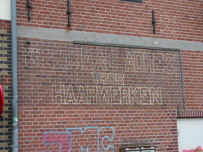 Faded advertisement for hairpieces