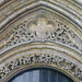 peterborough cathedral , the doorway to peterborough's refectory to the south of the cloister is very ornate, with gragons in the stiffleaf of its tympanum. it dates from the early mid c13.
