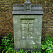 brompton cemetery, london,base of a broken cross, maybe early c20?, a memorial to a member of the  confraternity of men and women of st.andrews, wells st., that repository of high victorian arts that was bodily moved from the middle of town to the outer d