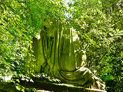 abney park cemetery, stoke newington, london,this kneeling figure may be on the tomb of harriet delph , 1944,  buried in the undergrowth like so many here