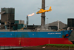 Flame, helicopter and ship