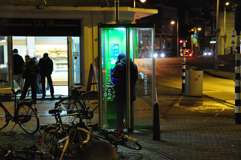 Somebody making a telephone call in a telephone box