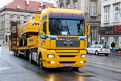 Trucks in Vienna: Yellow MAN truck with matching crane