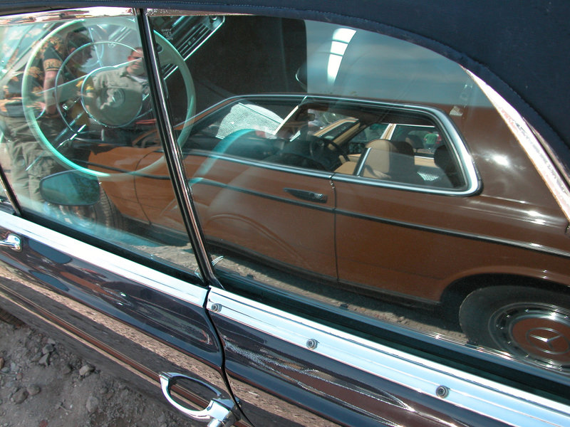 A Mercedes-Benz W123 Coupe reflected in a Mercedes-Benz 250 SE
