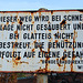 Old rusty sign warning that the road will not be treated when it is snowing