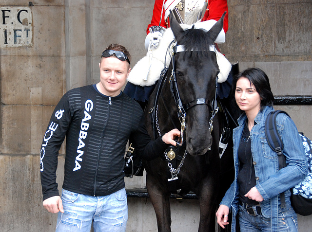 Tourist being photograph with a guardsman