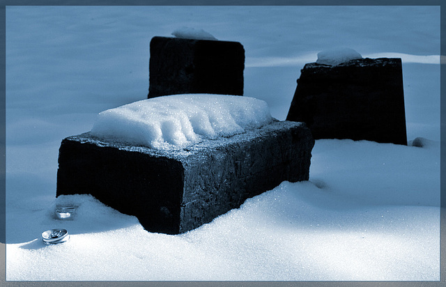 Blocks and Crushed Cans Covered with Snow