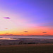 Summer skies and sunset over Findhorn Bay and the Moray Firth, with the lights of Kinloss, from Califer Viewpoint