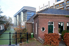 The Leiden University Medical Centre looming large over a old little building