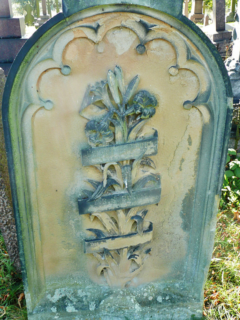 brompton cemetery, london,late c19 tombstone , illegible scroll over lilies