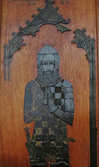 methwold church, norfolk,the important 1367 brass of sir adam de clinton is set into a board on the wall, covered up with a children's playpen when I visited
