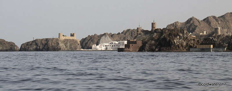 Forts Jalali and Merani guarding Muscat Bay. New Diwan and Royal Guard buildings on the shoreline where the former British Embassy stood