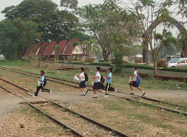 schoolchildren running to catch the train