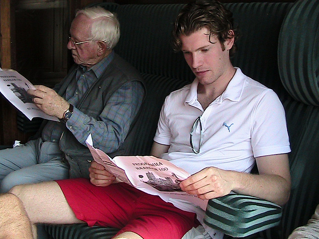 Celebration of the centenary of Haarlem Railway Station: Young and old reading the programme of the day in a first-class carriage