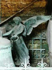 brompton cemetery, london,view inside the catacombs of 1838, built by baud.   the bell and angel appear to be from elsewhere in the cemetery.